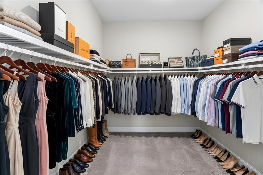 11992 Southwest 32nd Lane Gainesville, FL 32608 - Photo 13 of 29 a view of walk in closet with clothes and shoes