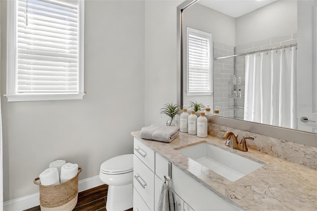 11992 Southwest 32nd Lane Gainesville, FL 32608 - Photo 15 of 29 a bathroom with a granite countertop sink and a toilet