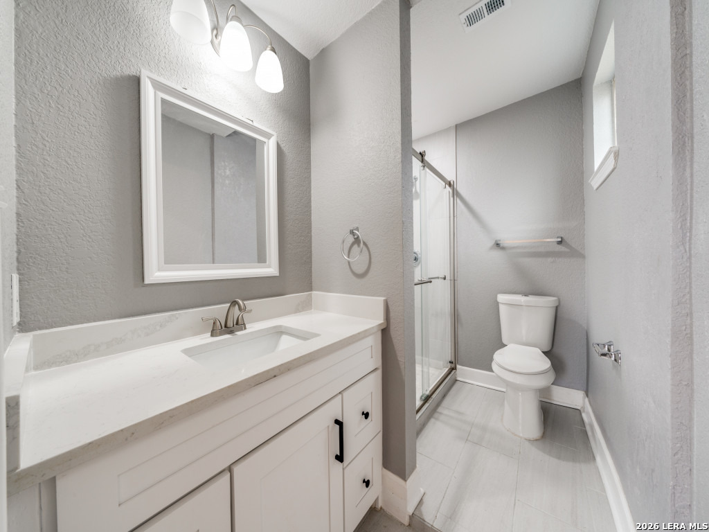 945 Potomac San Antonio, TX 78202 - Photo 12 of 14 a bathroom with a toilet sink and mirror