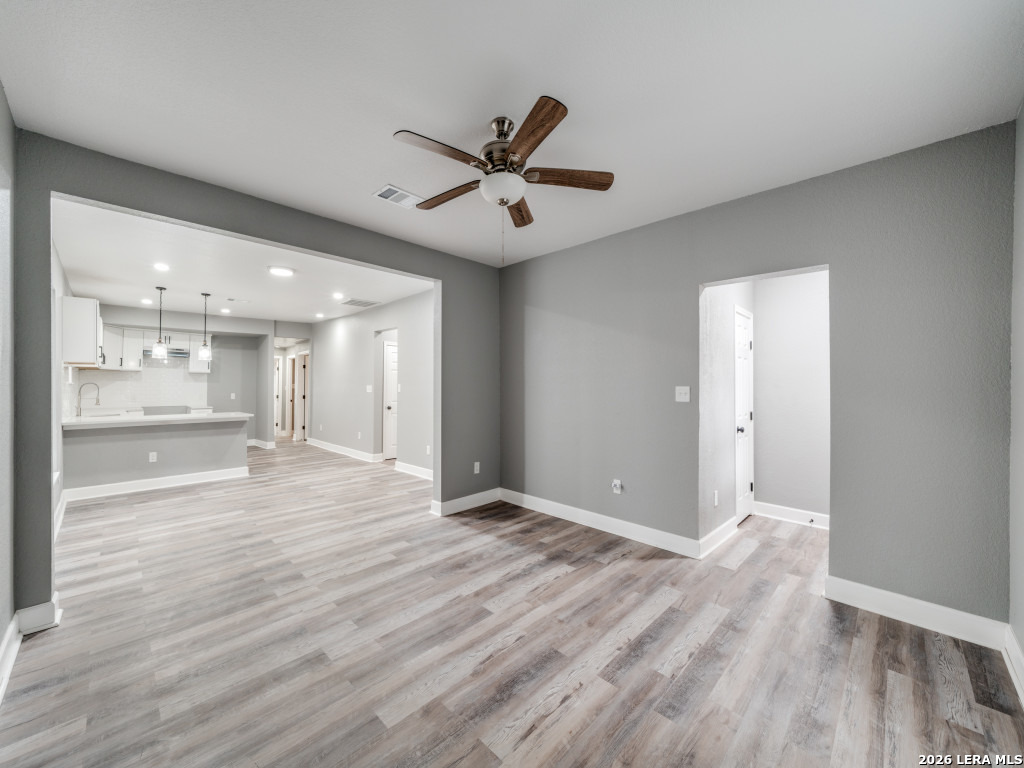 945 Potomac San Antonio, TX 78202 - Photo 3 of 14 wooden floor in an empty room with a window