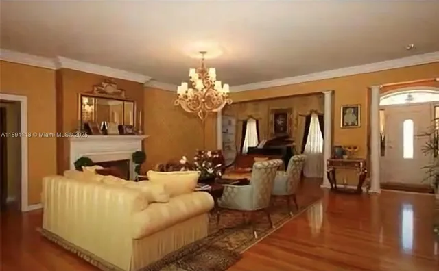 a living room with furniture and a chandelier