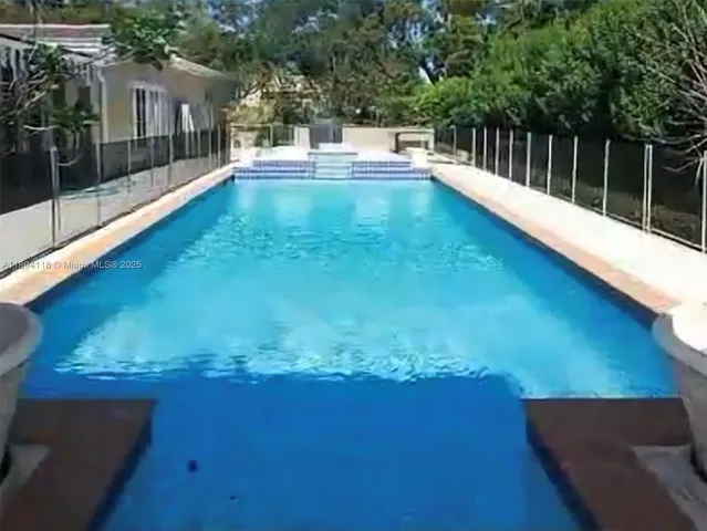 a view of a swimming pool with a yard