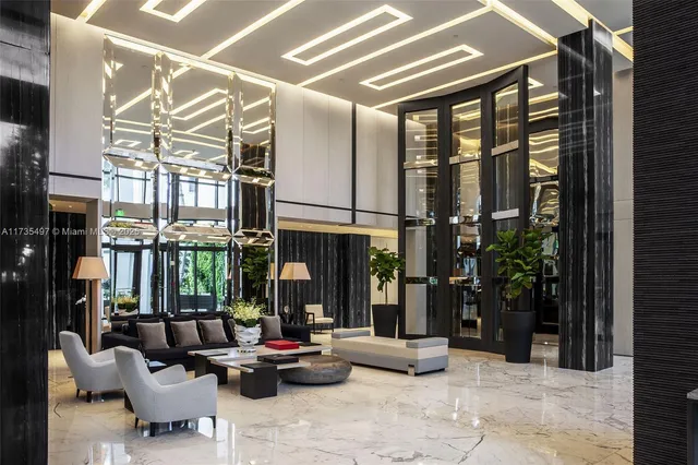 a dining room with furniture a chandelier and wooden floor