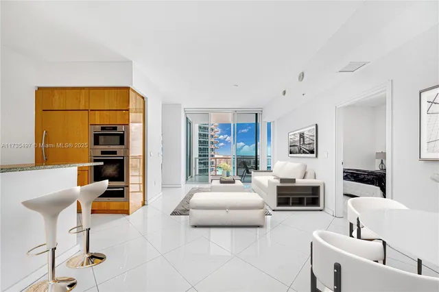 a living room with furniture and a kitchen