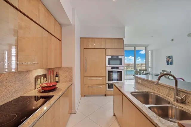 a kitchen with kitchen island a sink and refrigerator