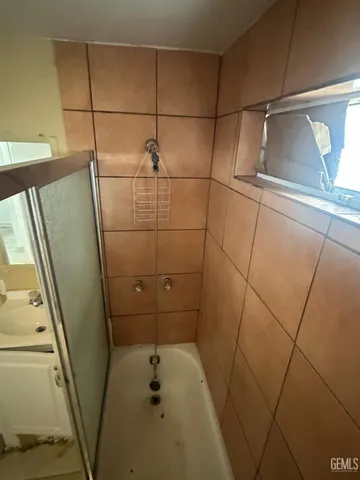 a bathroom with a shower and toilet