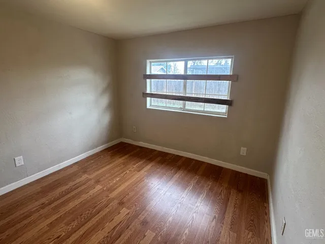a view of wooden floor in an empty room