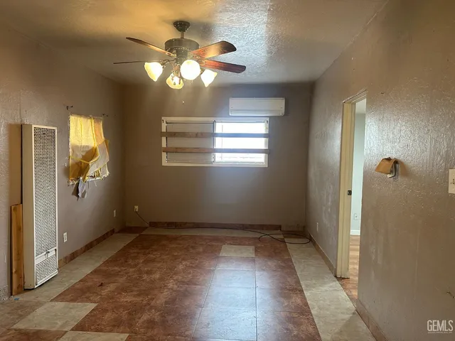a view of an empty room with window bathroom and front door