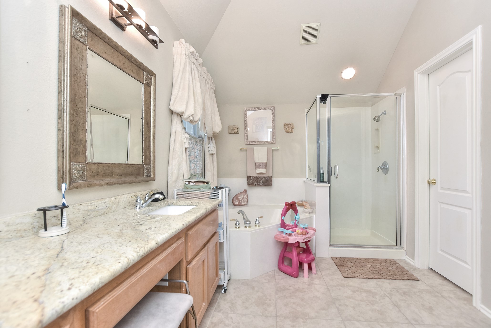 1609 Colton Way Cedar Park, TX 78613 - Photo 12 of 24 Indulge in a bathroom retreat featuring a spacious walk-in shower and a corner soaking tub.