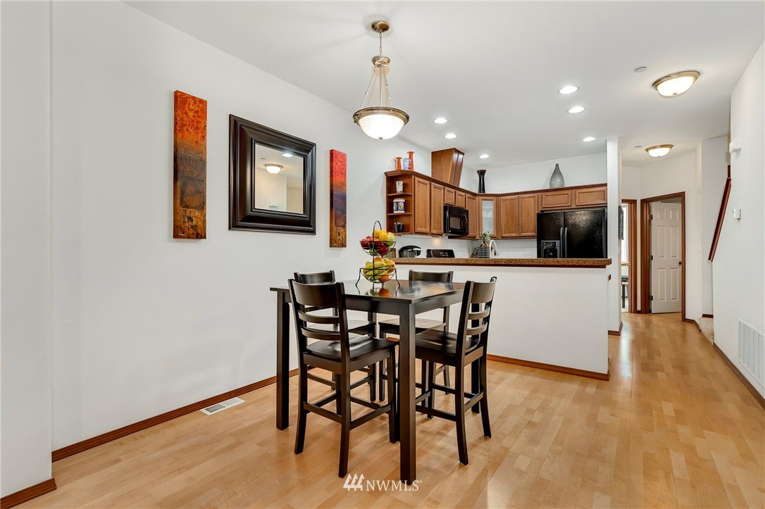 21351 11th Drive Southeast Bothell, WA 98021 - Photo 11 of 33 a view of a dining room with furniture and wooden floor