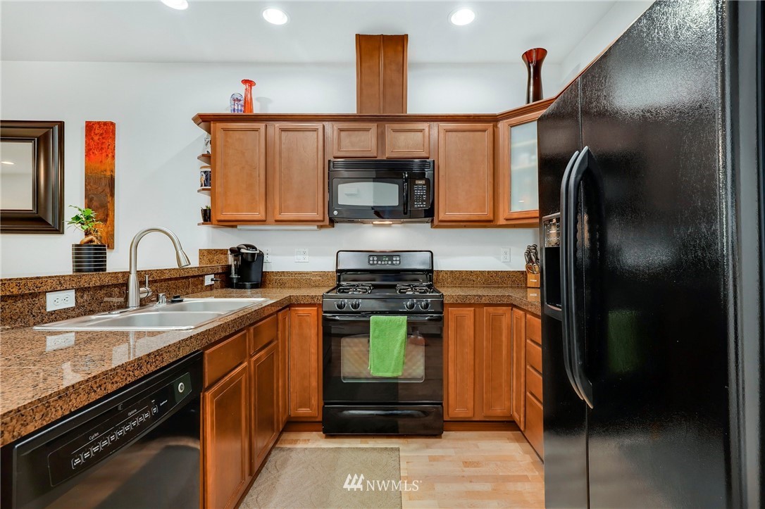 21351 11th Drive Southeast Bothell, WA 98021 - Photo 13 of 33 a kitchen with stainless steel appliances granite countertop a stove and a refrigerator
