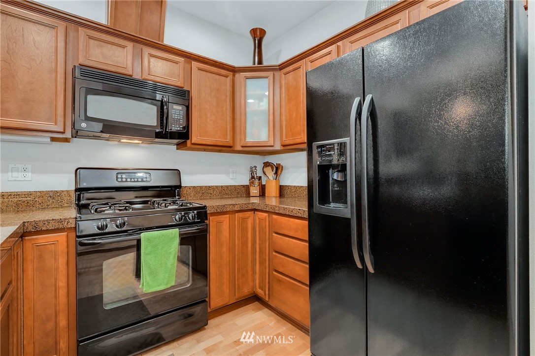 21351 11th Drive Southeast Bothell, WA 98021 - Photo 14 of 33 a kitchen with stainless steel appliances granite countertop a refrigerator stove and microwave