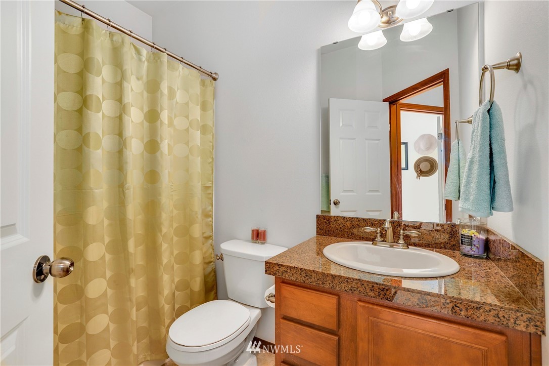 21351 11th Drive Southeast Bothell, WA 98021 - Photo 17 of 33 a bathroom with a granite countertop sink toilet and shower