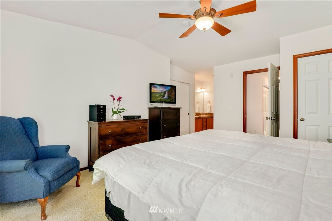 21351 11th Drive Southeast Bothell, WA 98021 - Photo 20 of 33 a bedroom with a bed and a chandelier