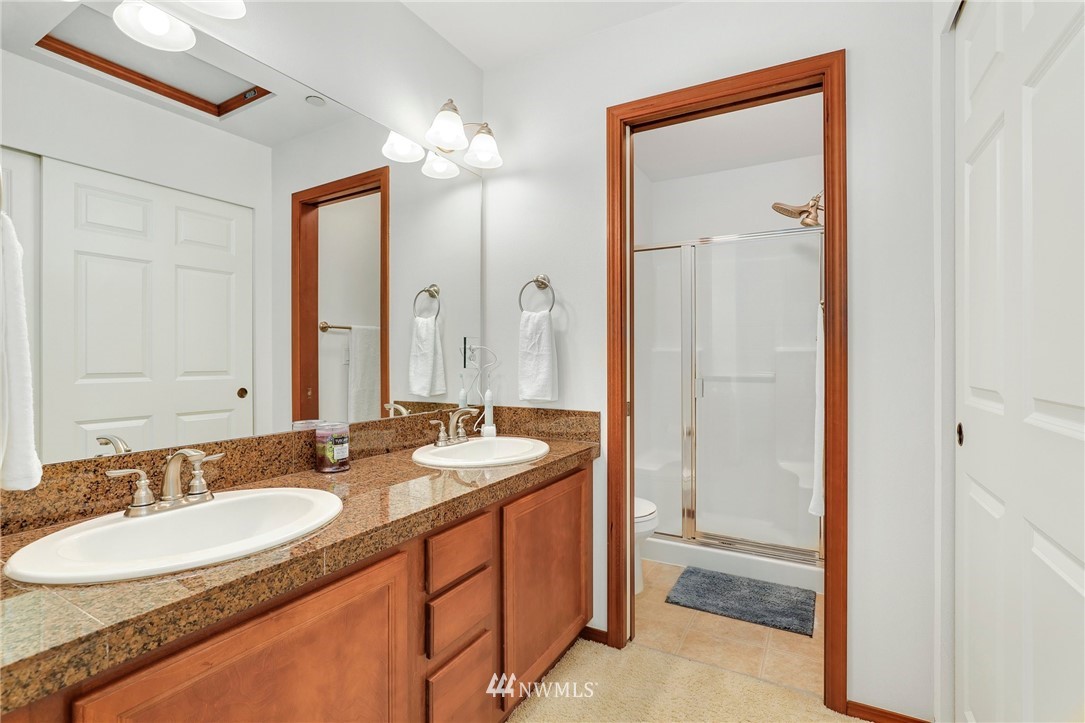 21351 11th Drive Southeast Bothell, WA 98021 - Photo 21 of 33 a bathroom with a granite countertop sink and a mirror