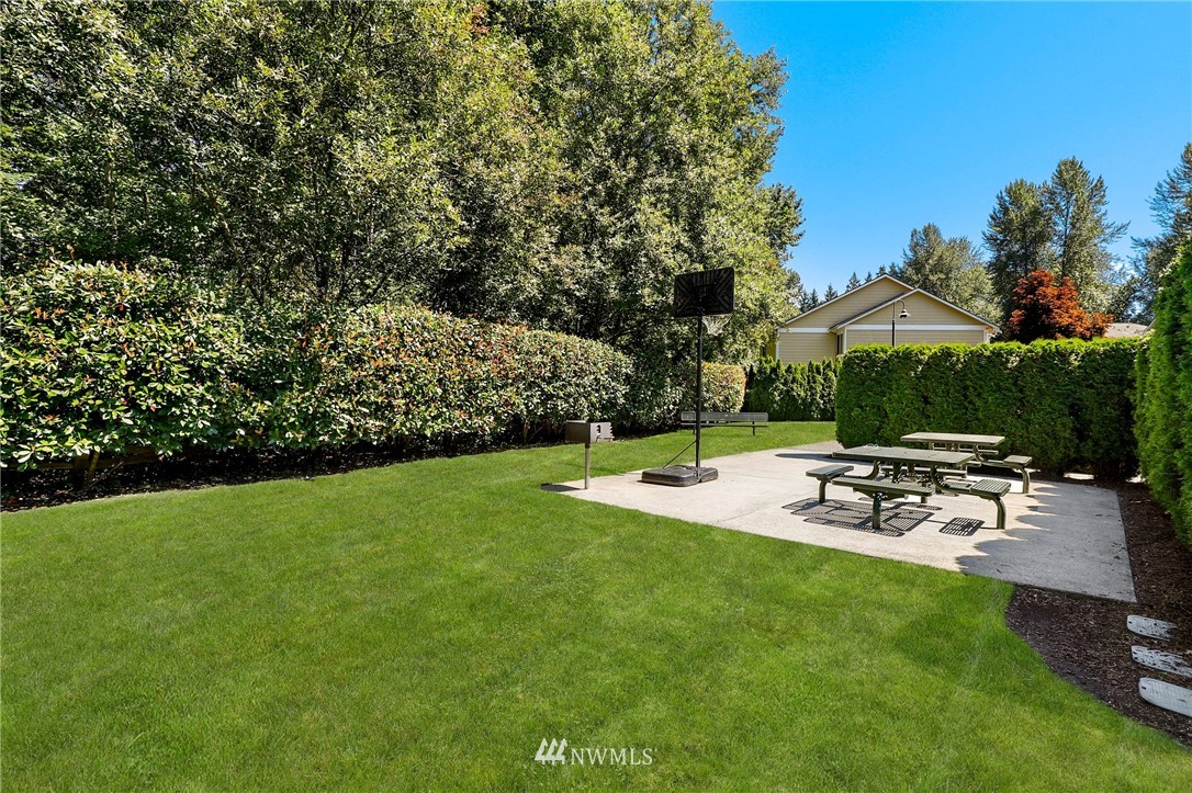 21351 11th Drive Southeast Bothell, WA 98021 - Photo 31 of 33 a view of a patio with table and chairs under an umbrella