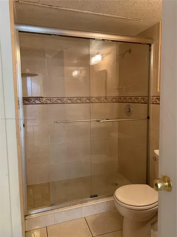 a bathroom with a shower and a toilet
