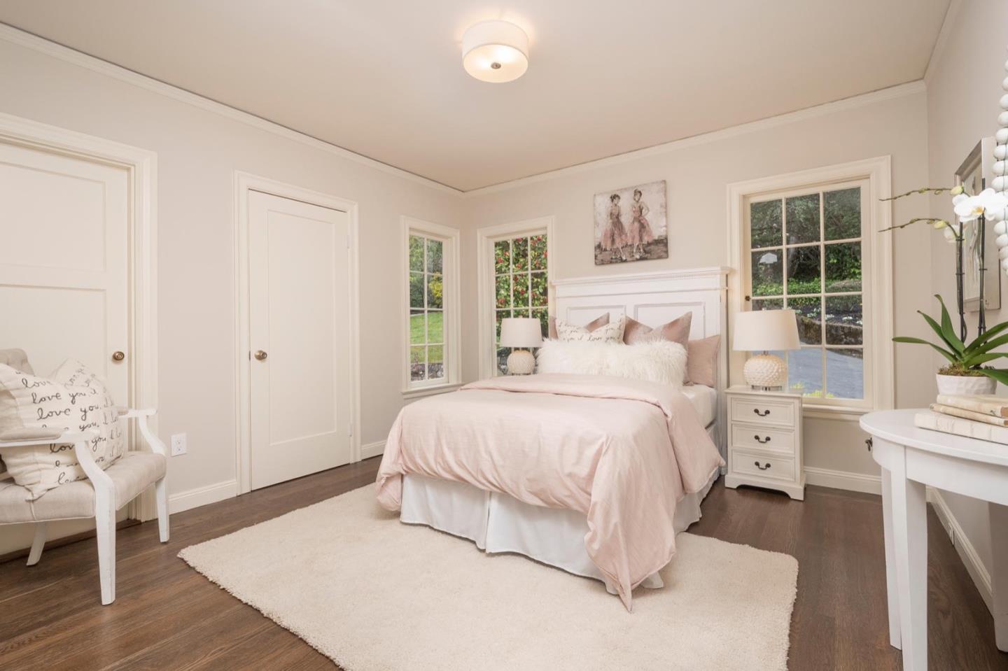 900 Link Road Hillsborough, CA 94010 - Photo 33 of 52 a bedroom with a white bed and white walls with wooden floor