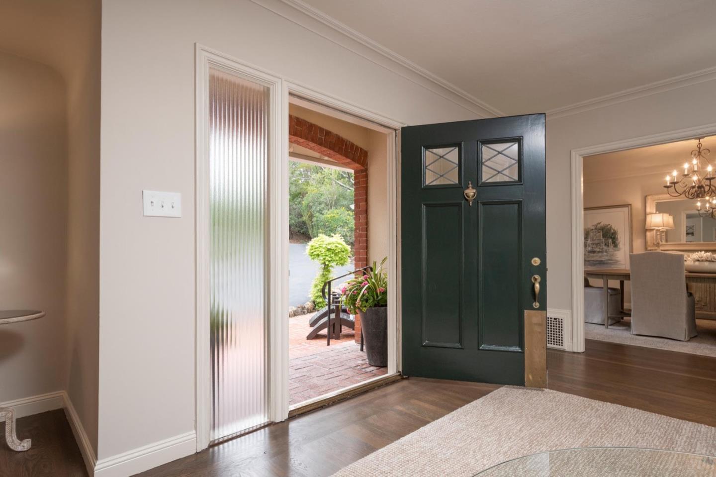 900 Link Road Hillsborough, CA 94010 - Photo 6 of 52 a view of a hallway with wooden floor and a livingroom