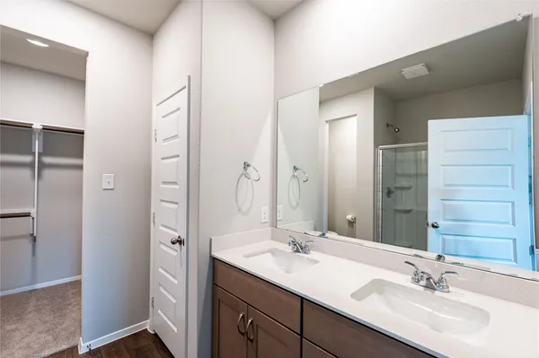 a bathroom with a shower sink and mirror