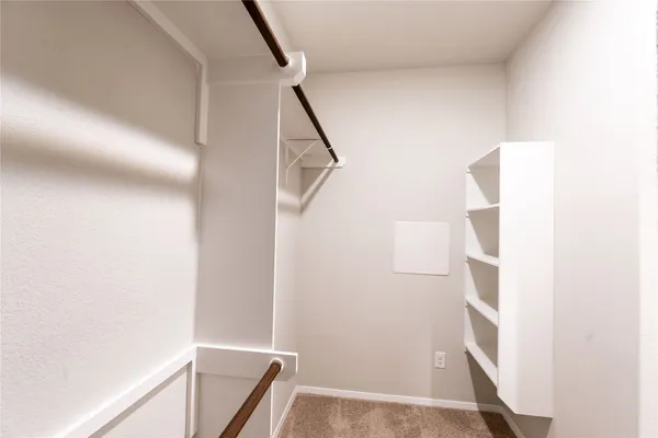 a view of an empty room with closet area