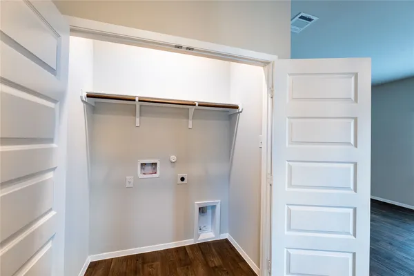 an empty room with closet and a chandelier fan
