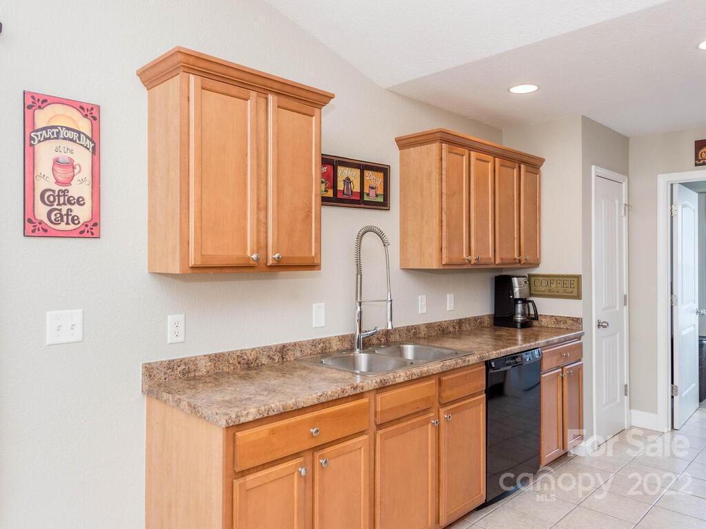 243 Scarlett Ridge Drive Marshall, NC 28753 - Photo 17 of 36 a kitchen with stainless steel appliances granite countertop a sink and dishwasher with wooden floor