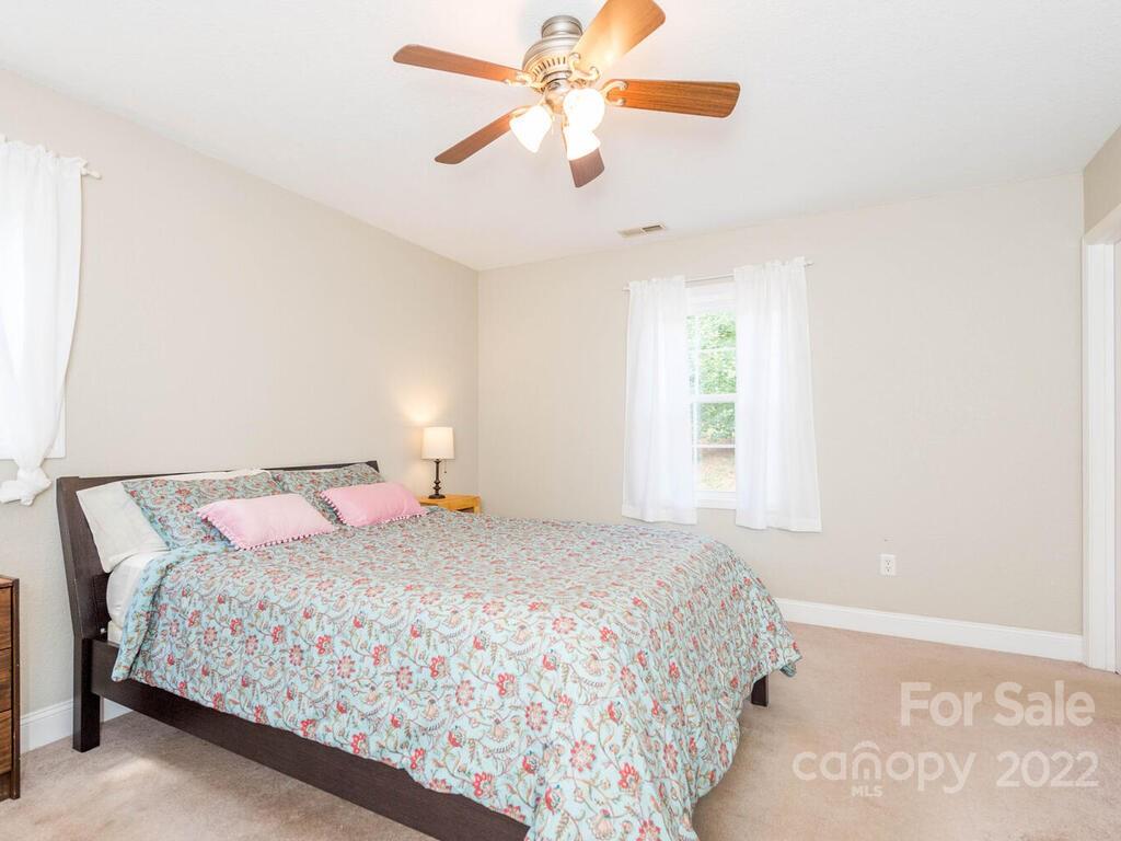 243 Scarlett Ridge Drive Marshall, NC 28753 - Photo 21 of 36 a bedroom with a bed and a window