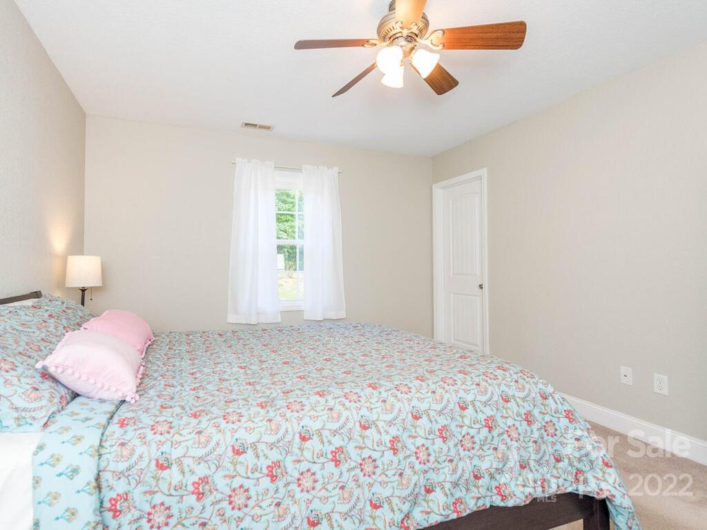 243 Scarlett Ridge Drive Marshall, NC 28753 - Photo 22 of 36 a bedroom with a bed and a window
