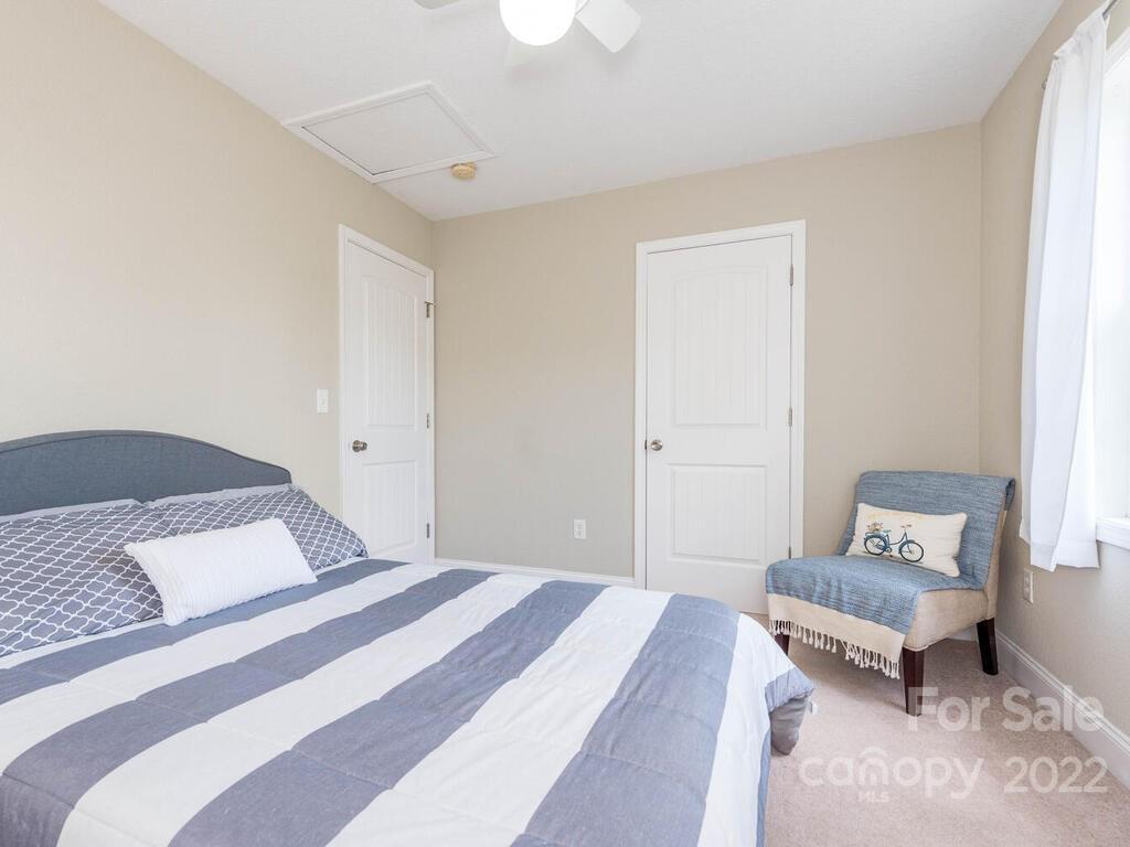 243 Scarlett Ridge Drive Marshall, NC 28753 - Photo 27 of 36 a bedroom with a bed and wooden floor