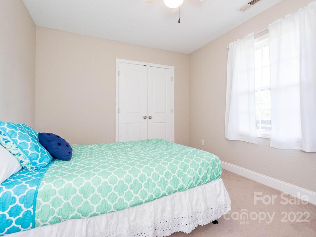 243 Scarlett Ridge Drive Marshall, NC 28753 - Photo 28 of 36 a bedroom with a bed and a window