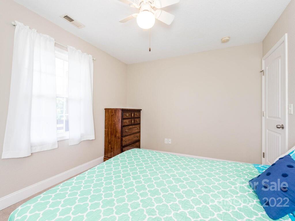243 Scarlett Ridge Drive Marshall, NC 28753 - Photo 29 of 36 a bedroom with a bed and a chandelier