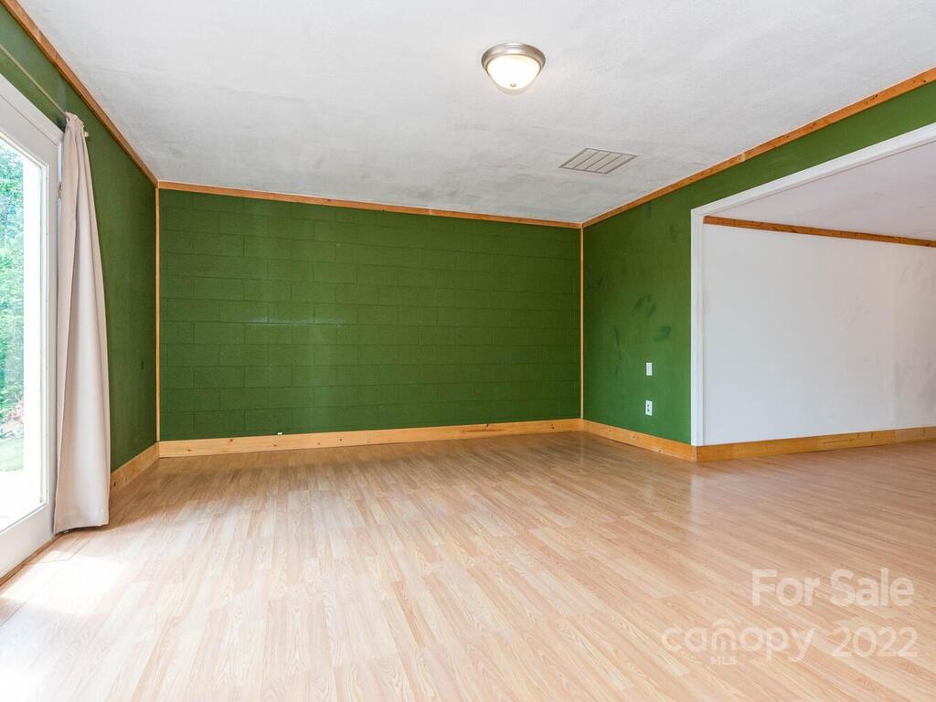 243 Scarlett Ridge Drive Marshall, NC 28753 - Photo 31 of 36 an empty room with wooden floor and windows