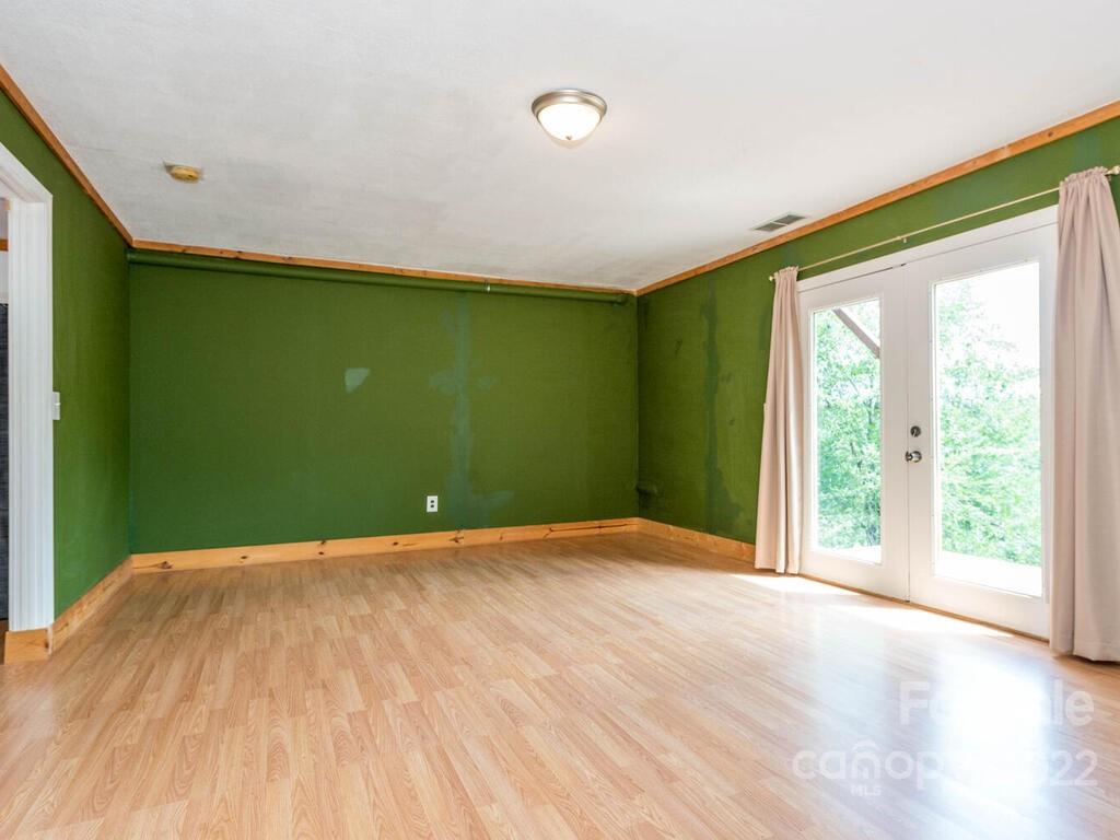 243 Scarlett Ridge Drive Marshall, NC 28753 - Photo 32 of 36 a view of a big room with wooden floor and windows