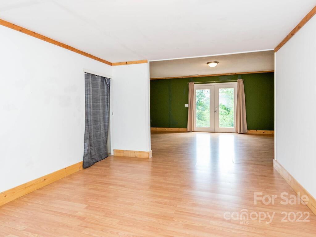 243 Scarlett Ridge Drive Marshall, NC 28753 - Photo 33 of 36 a view of an empty room with wooden floor and a window