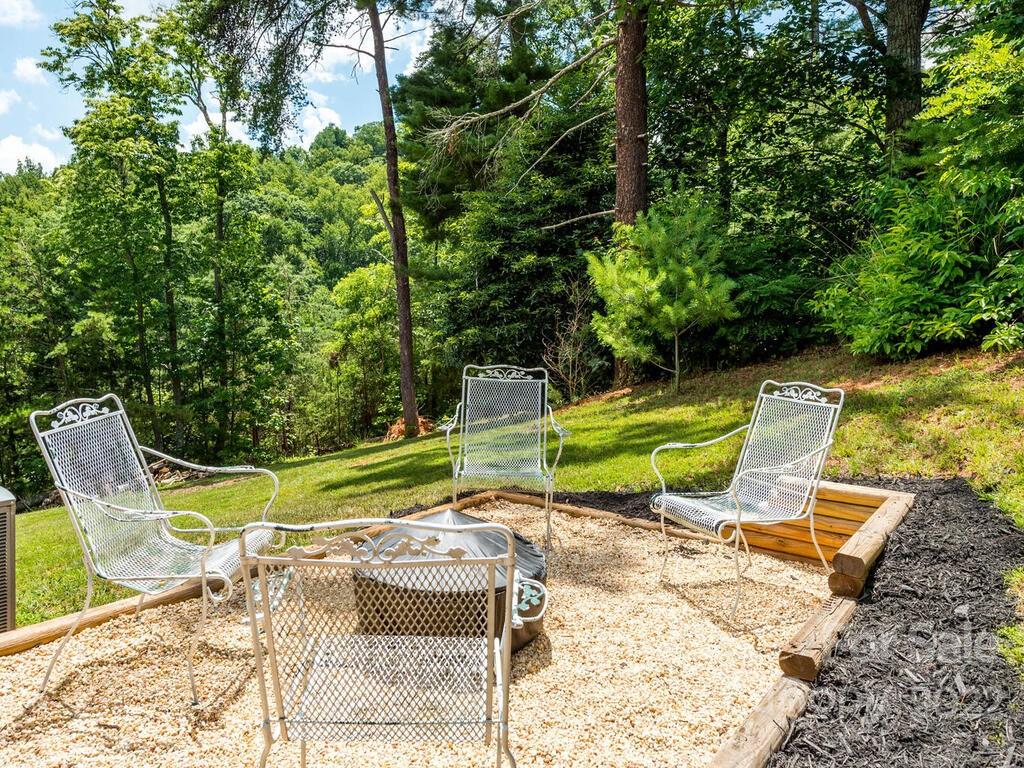 243 Scarlett Ridge Drive Marshall, NC 28753 - Photo 10 of 36 a view of a swimming pool with a lounge chairs