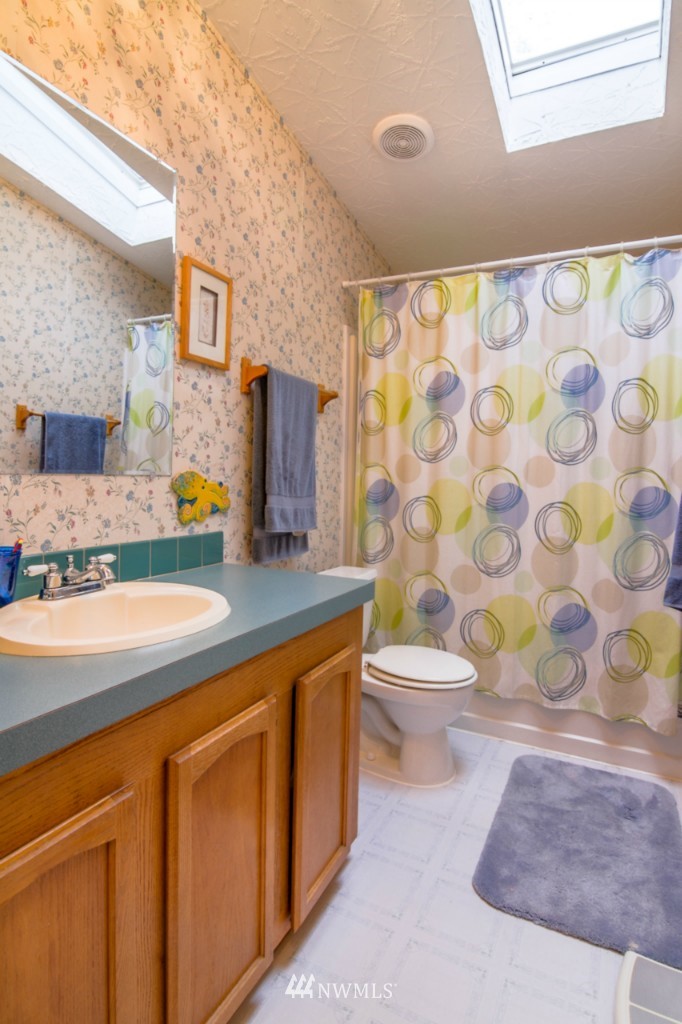 3554 Loomis Trail Road Blaine, WA 98230 - Photo 13 of 23 a bathroom with a granite countertop sink a toilet and a mirror