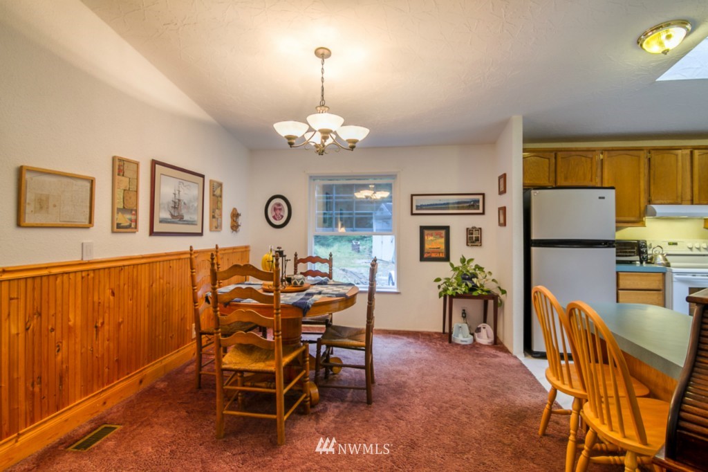 3554 Loomis Trail Road Blaine, WA 98230 - Photo 6 of 23 a view of a dining room with furniture and chandelier