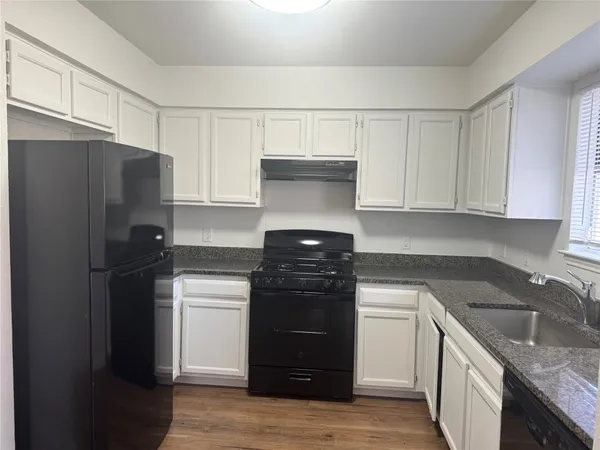 a kitchen with a stove and a refrigerator