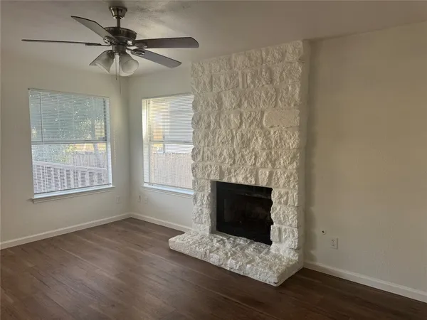 a living room with a fireplace and a window