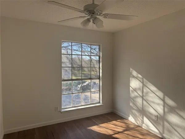 a view of a room with wooden floor
