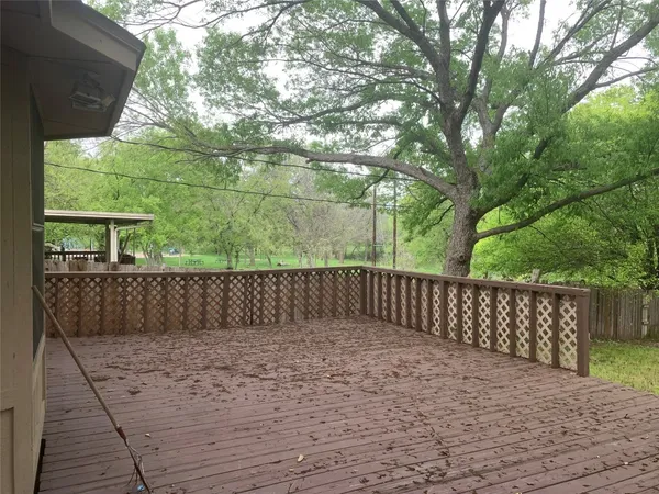 a view of a yard with wooden fence