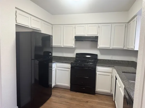 a kitchen with a refrigerator and a stove