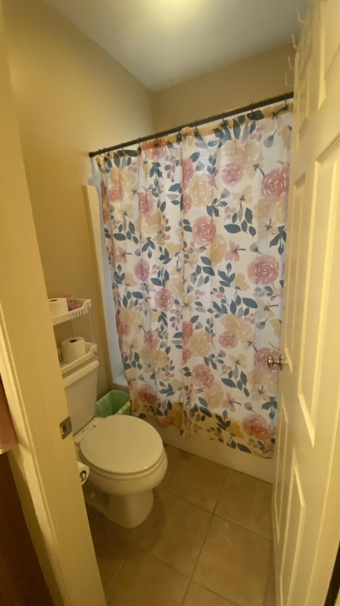 37894 Medway Street Indio, CA 92203 - Photo 19 of 27 a white toilet sitting next to a shower curtain