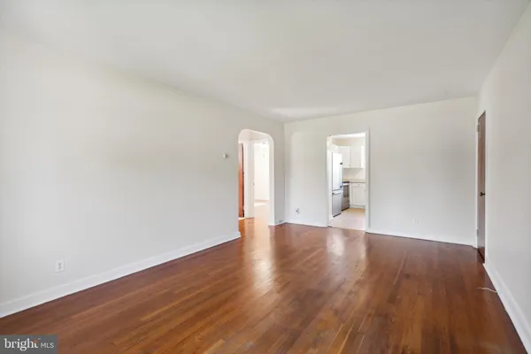 a view of an empty room and wooden floor