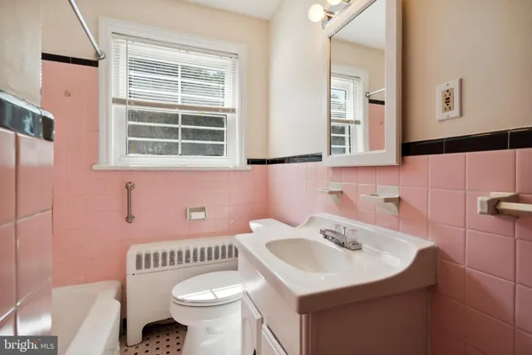 a bathroom with a sink toilet and a mirror