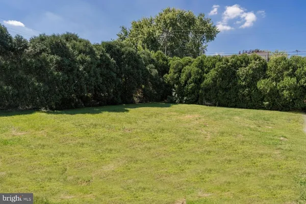 a view of a yard with a house in the background