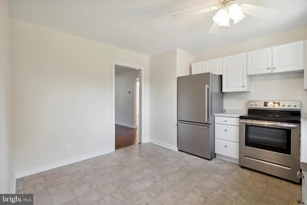 a kitchen with a stainless steel appliances a refrigerator and a stove top oven