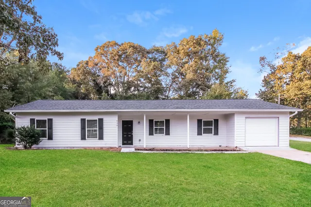 a front view of a house with a garden
