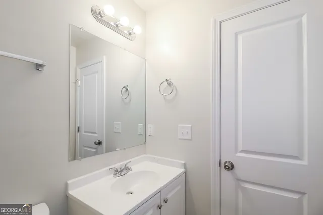 a bathroom with a sink a mirror and shower
